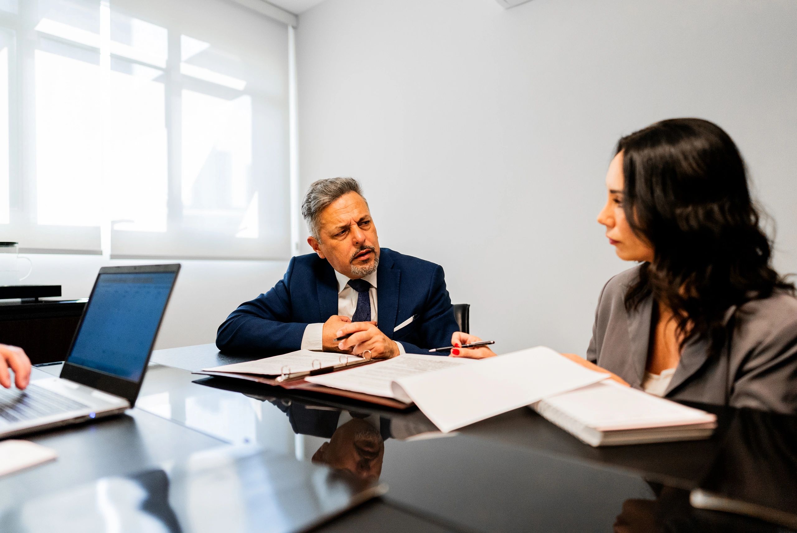 Professionals speaking in an office consultation setting